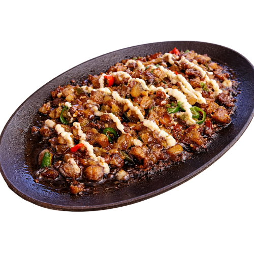 Sizzling pork sisig served on a hot plate.