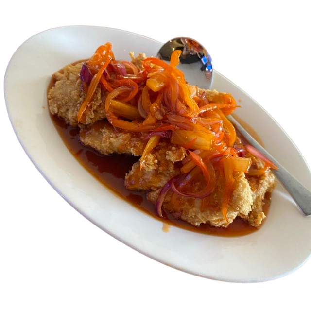 Sweet and sour fish with vegetables on a plate.