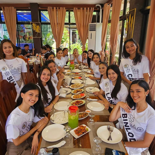 Group of women dining together at Mangroves Cafe & Restaurant, seated at a long table with shared Filipino dishes.