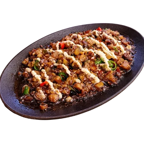 Sizzling pork sisig served on a hot plate.