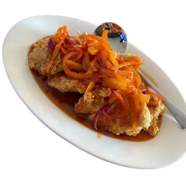 Sweet and sour fish with vegetables on a plate.