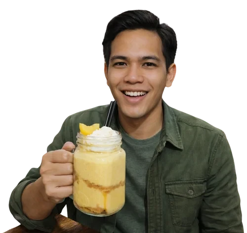 Customer holding a mango shake with whipped cream.