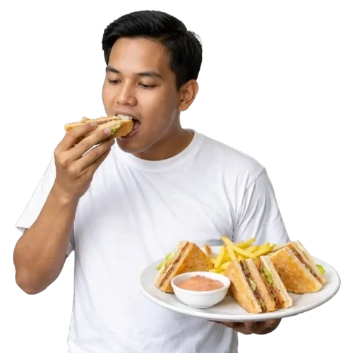 Customer eating a sandwich with fries and dipping sauce.